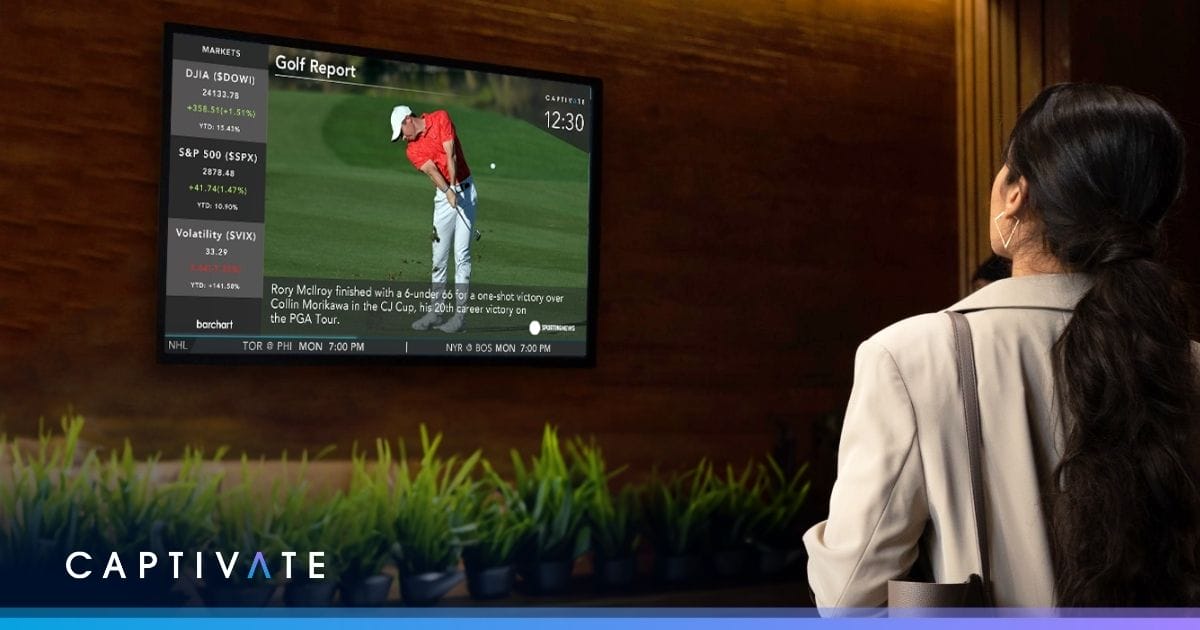 Woman watching a screen displaying a golf report and business news.