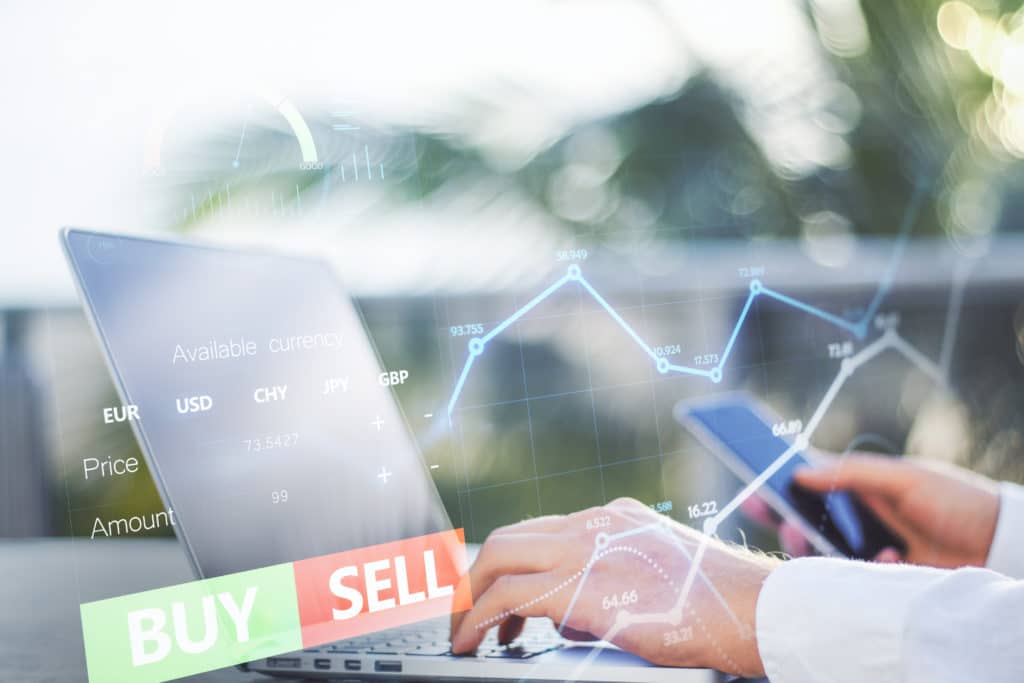 close-up-hands-using-laptop-cellphone-with-forex-chart-sell-buy-buttons-blurry-background-stock-exchange-cryptocurrency-global-fund-information-concept-double-exposure.