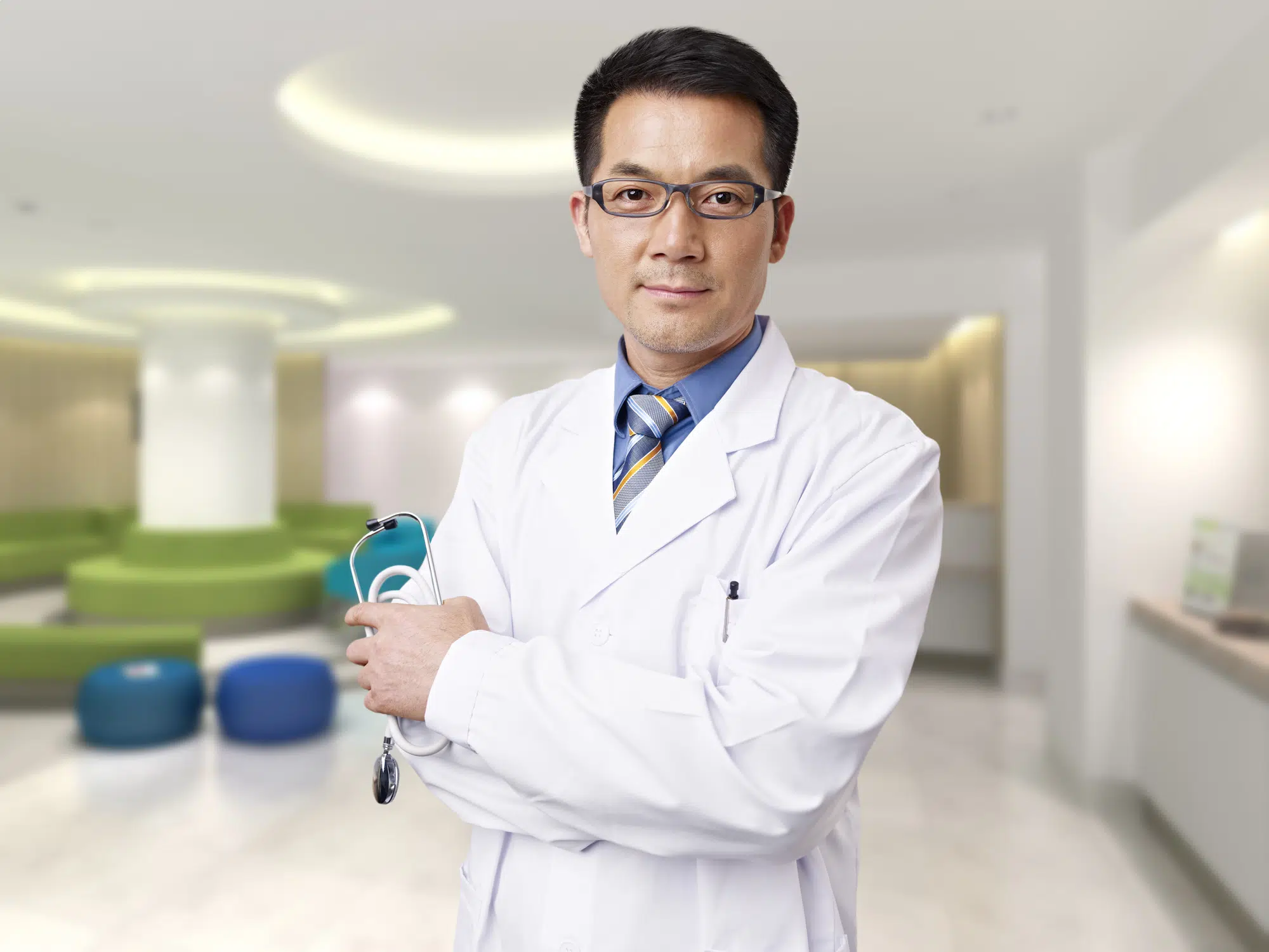 portrait of a male asian doctor in hospital lobby.