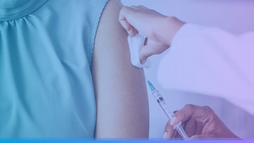 Healthcare professional administering vaccine to a person's arm, using a syringe and cotton swab in a clinical setting.