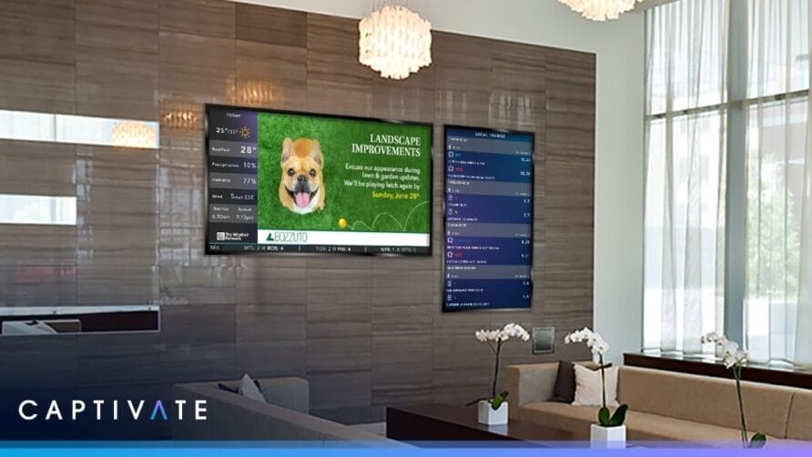 Digital display in modern office lobby showing weather, news, and advertisement with a dog promoting landscape improvements.