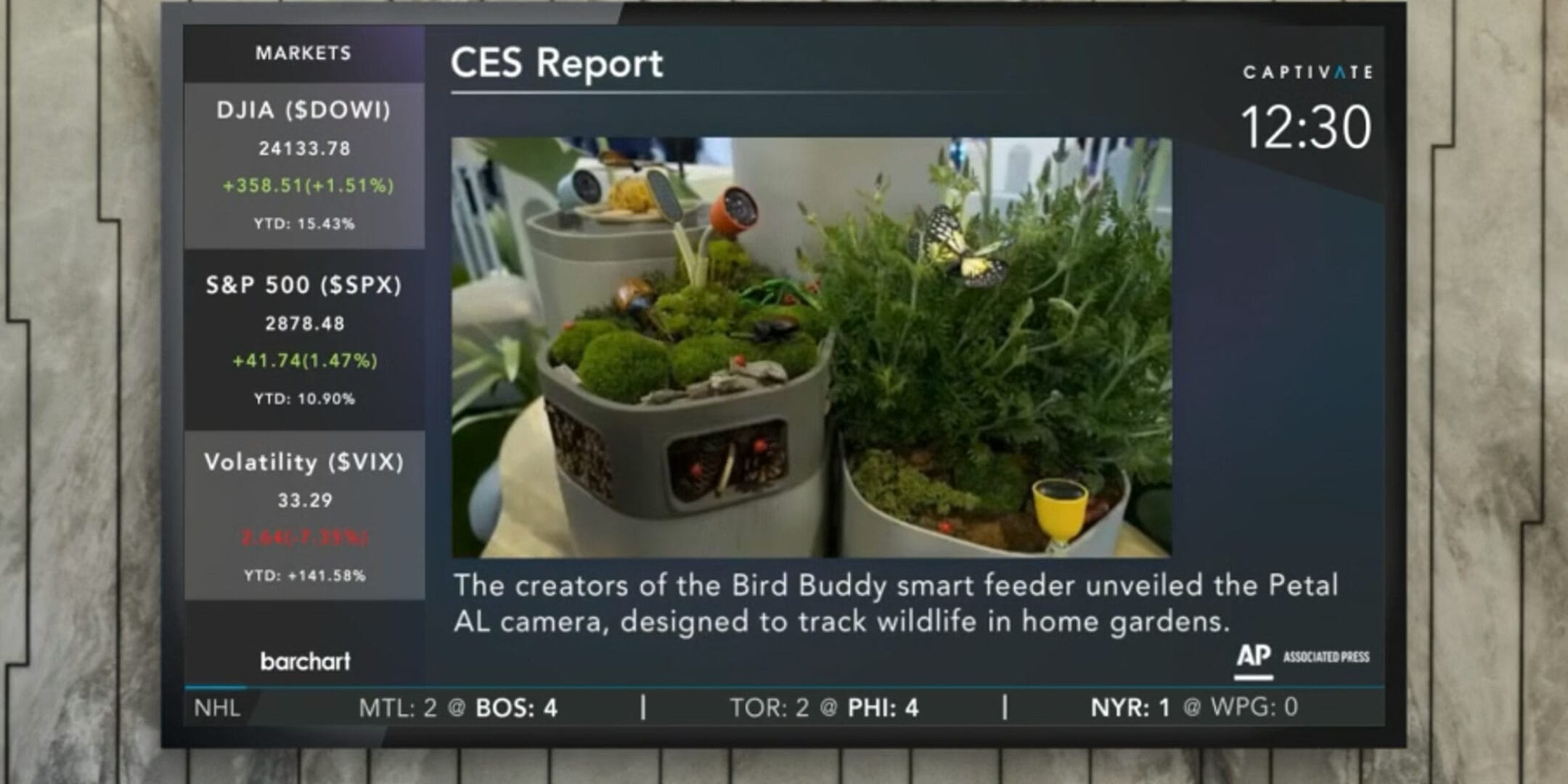 TV screen displaying a CES report about smart planters with small plants and text overlay detailing their features.