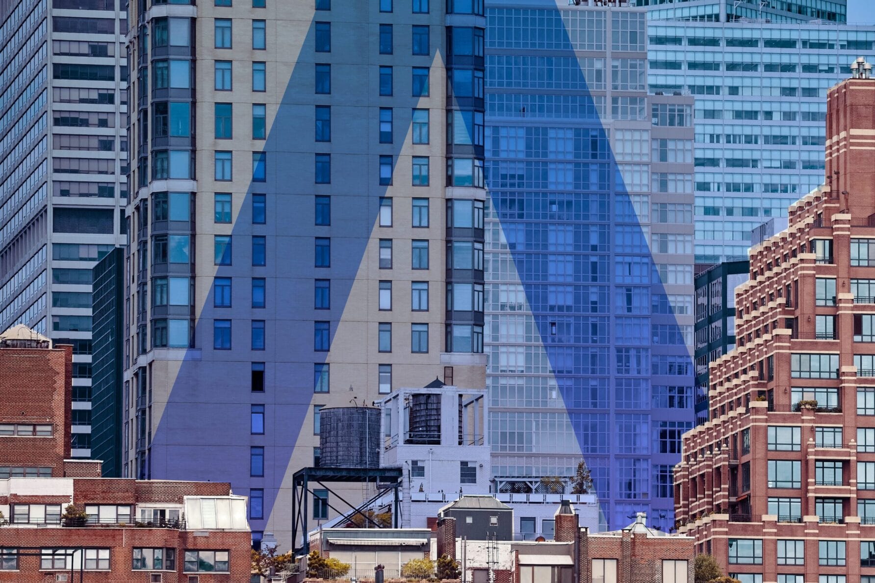 Manhattan skyline with a large, stylized blue letter "A" superimposed over the buildings.