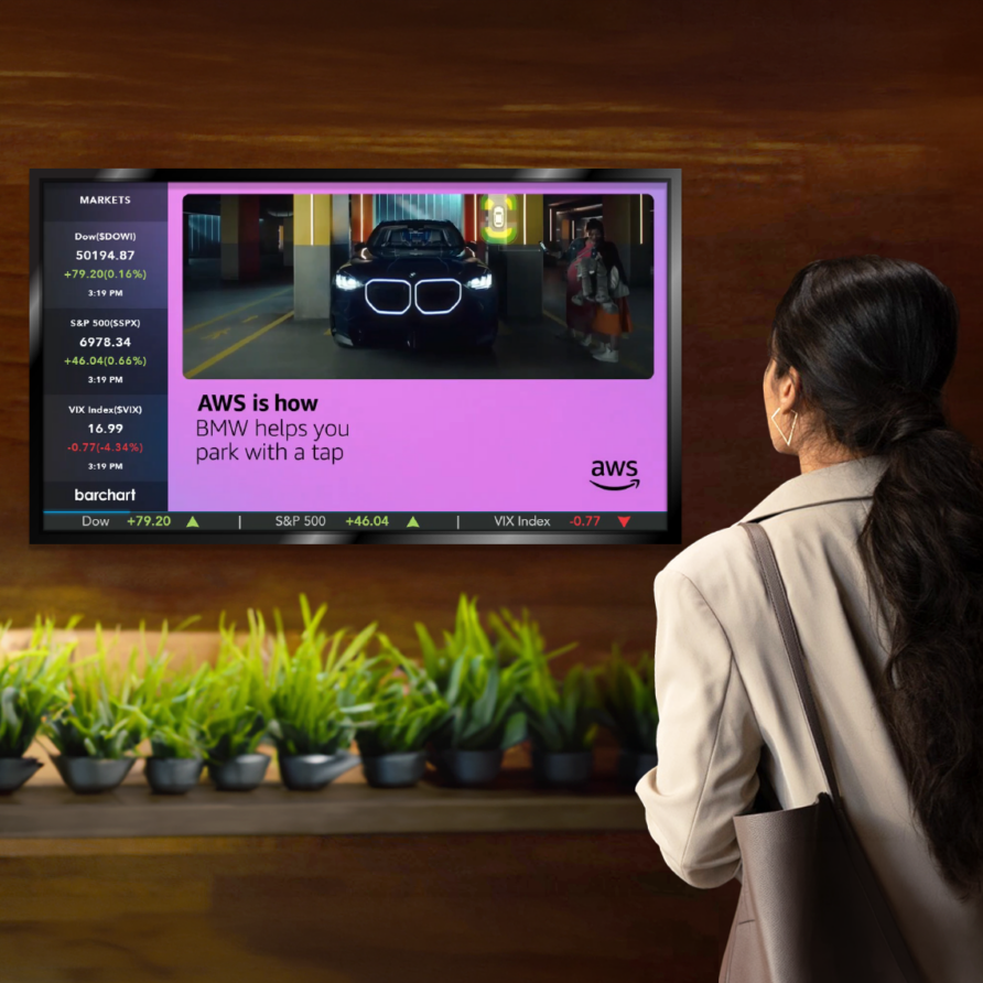 Woman watching a TV commercial featuring a car in a vibrant room with potted plants below the screen.