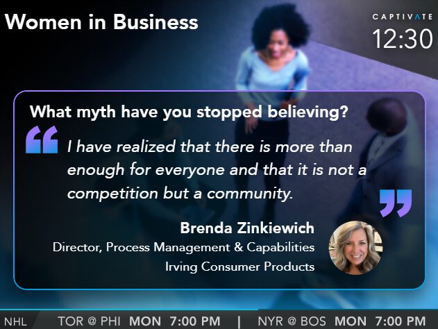 A person speaking at a Women in Business event, discussing community over competition.