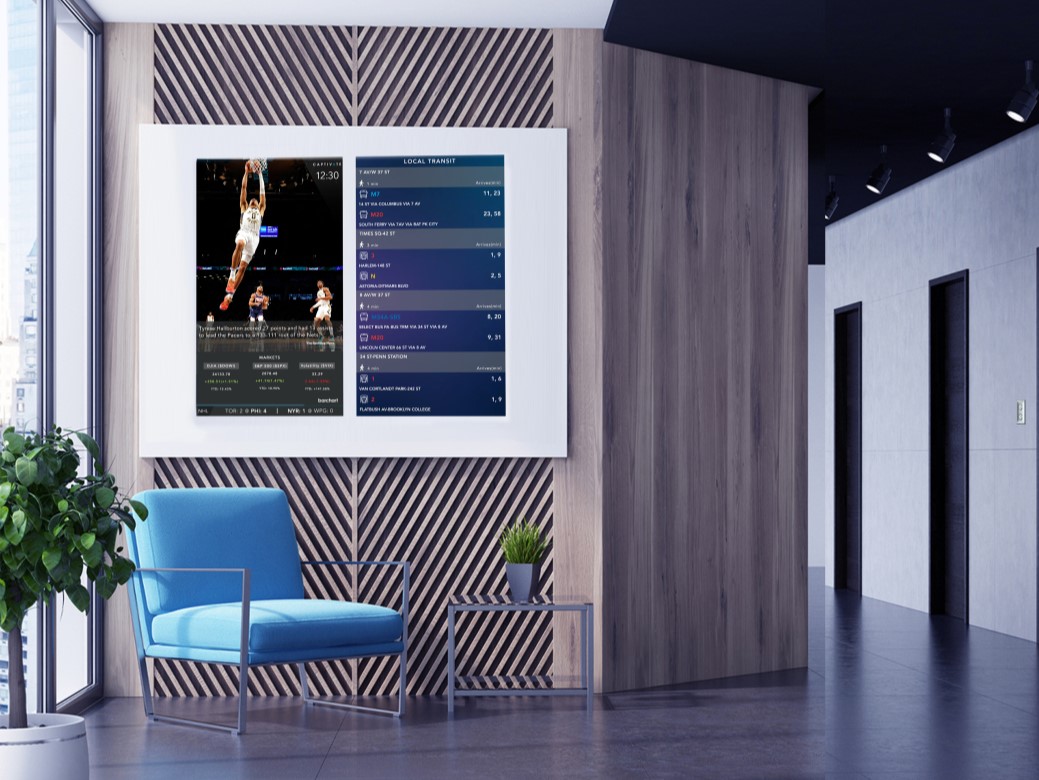 Modern office lounge with a digital screen displaying basketball game stats and a blue chair with a small table.