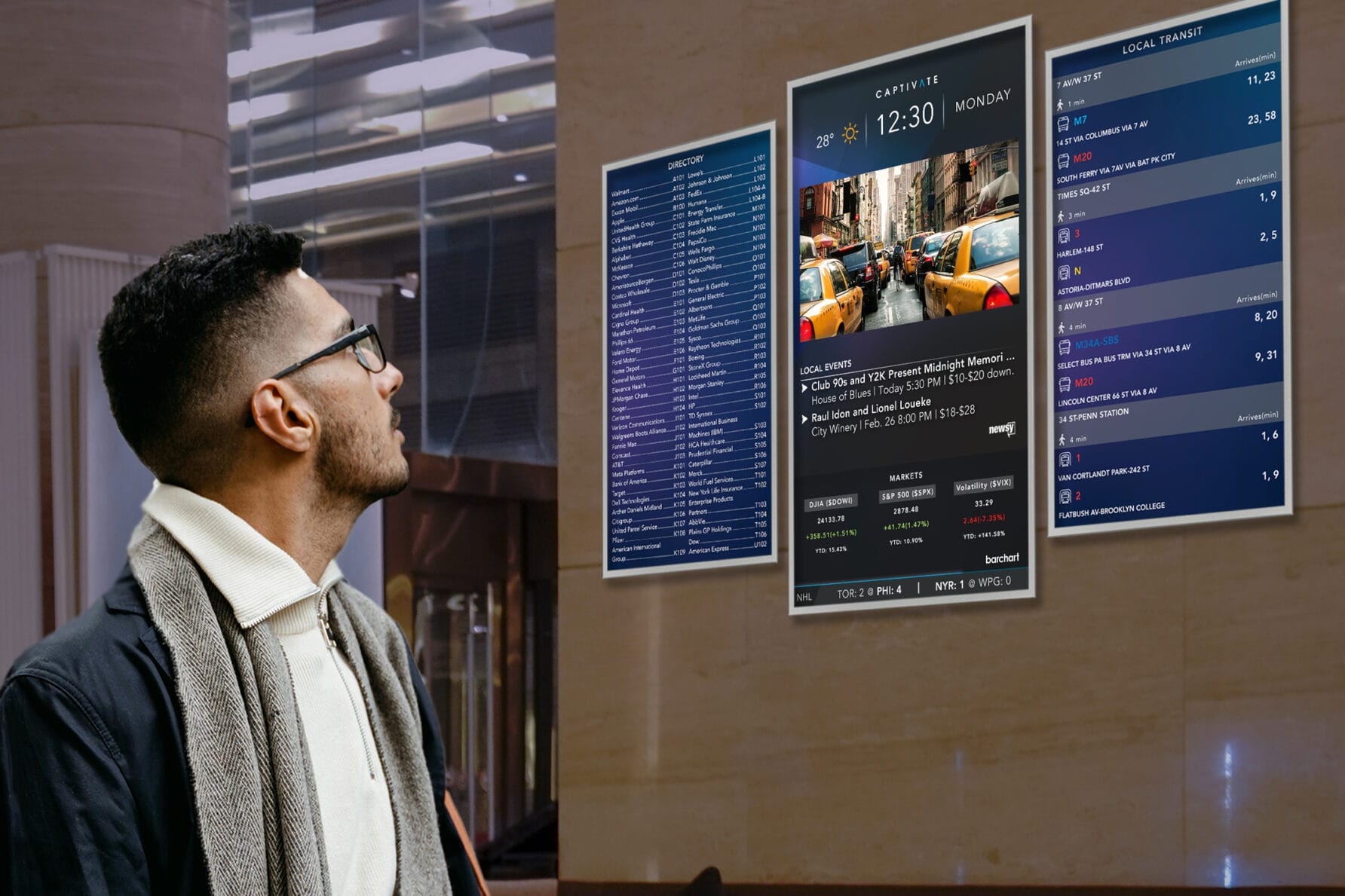 Man looking at digital restaurant menu displays on a wall in a modern setting, wearing a scarf and glasses.
