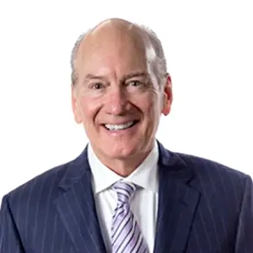 Smiling man in a suit and tie against a white background