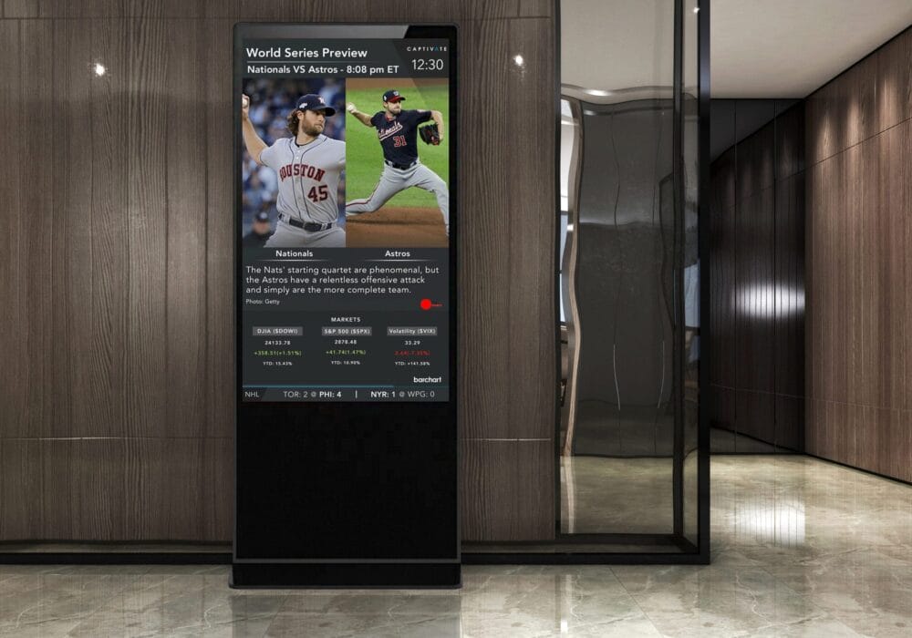 Digital display in a modern hallway showing sports news with images of two athletes in action.