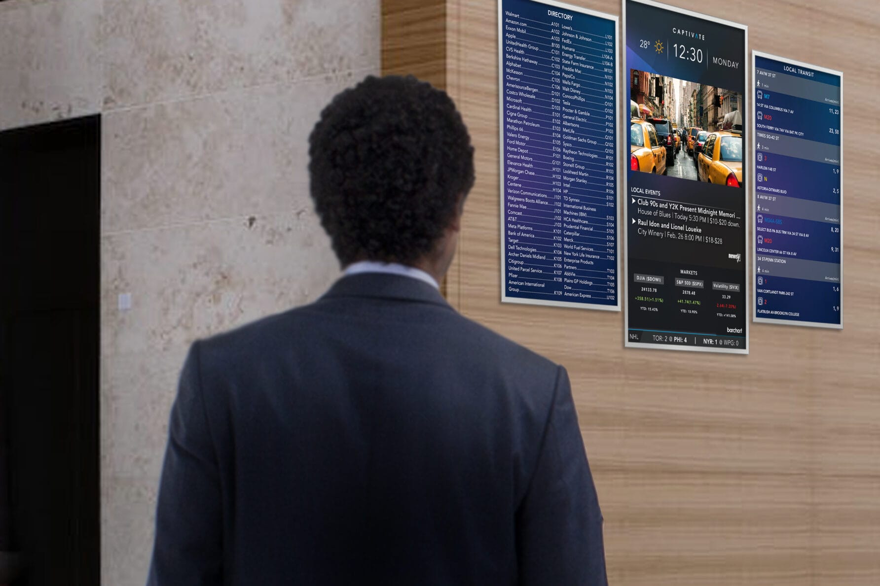 Person in a suit looking at large digital menu displays on a modern building wall.