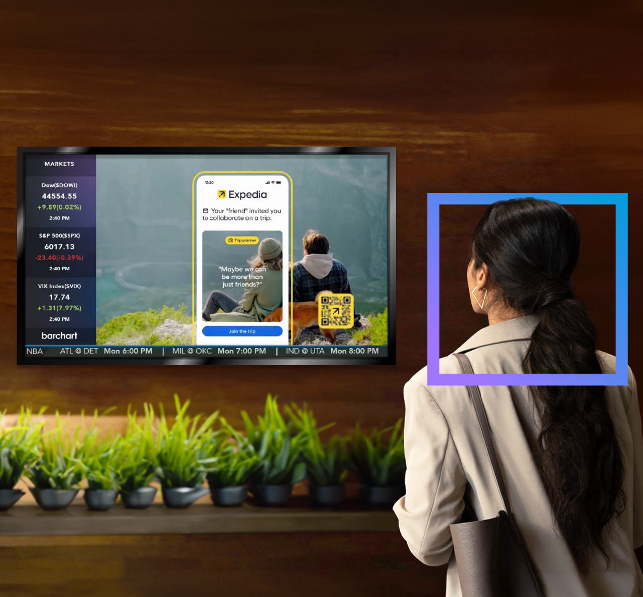 Person standing in front of a TV displaying a program guide, with potted plants lined up below the screen.