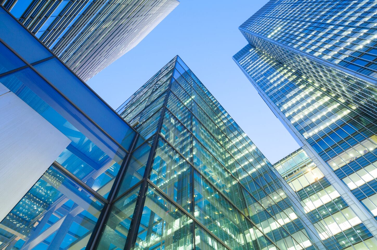 modern glass skyscrapers reflecting blue sky on a clear day