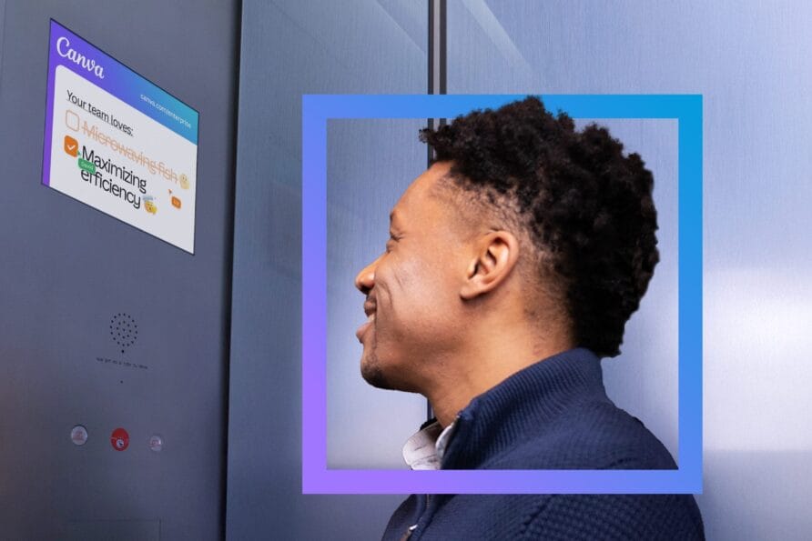 Man standing sideways with a blue frame around his head, looking at a screen on a metallic wall.