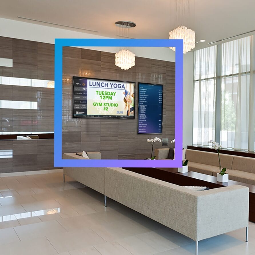 Modern lobby with beige sofas, wall-mounted screen, and large windows allowing natural light.