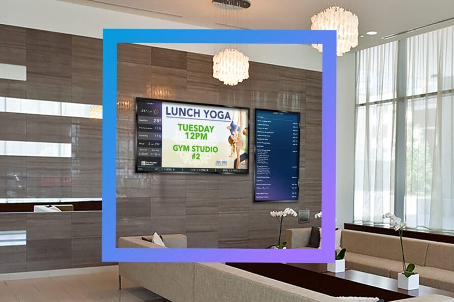 Lobby with digital screens displaying a lunch yoga event and a directory in a modern office building.