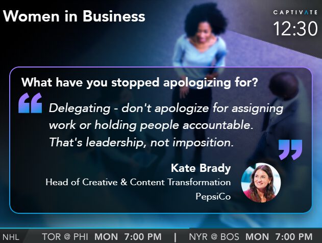 "Quote about leadership by Kate Brady displayed on a digital screen at a conference"