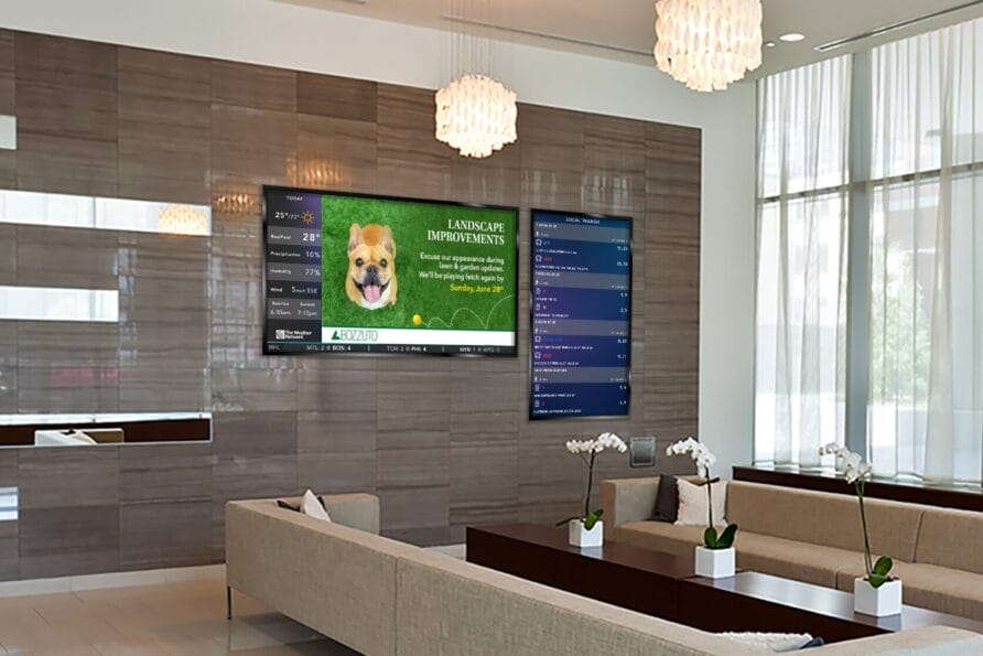 Modern lobby with seating, wall-mounted screen displaying financial updates, and potted orchids on the coffee table.