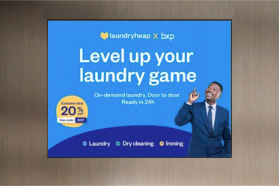 On-demand laundry service ad with special offer, featuring a smiling man in a suit pointing upwards.
