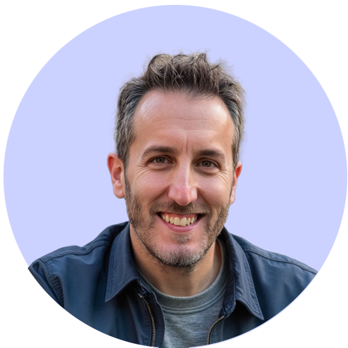 Smiling man in a denim shirt against a light purple background in a circular frame.