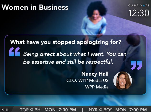 TV screen displaying a quote about being assertive from a CEO, featuring a blurred background with people in business attire.