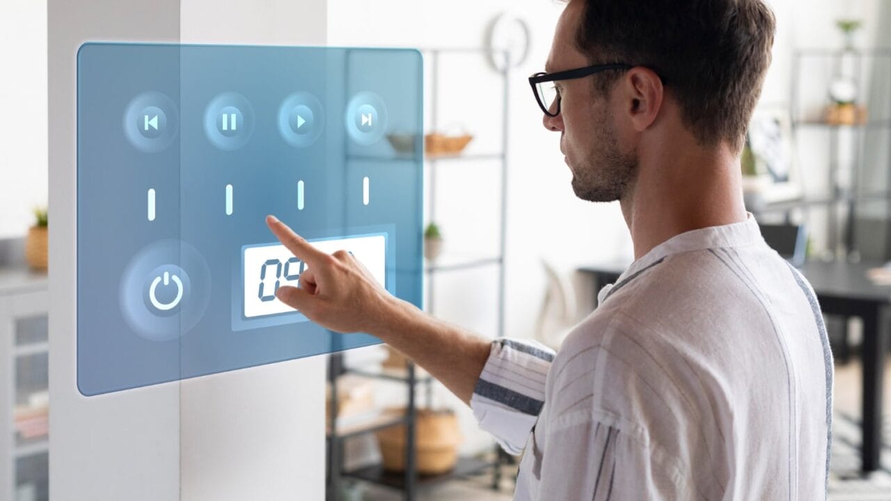 Man using futuristic touchscreen interface in modern living room.