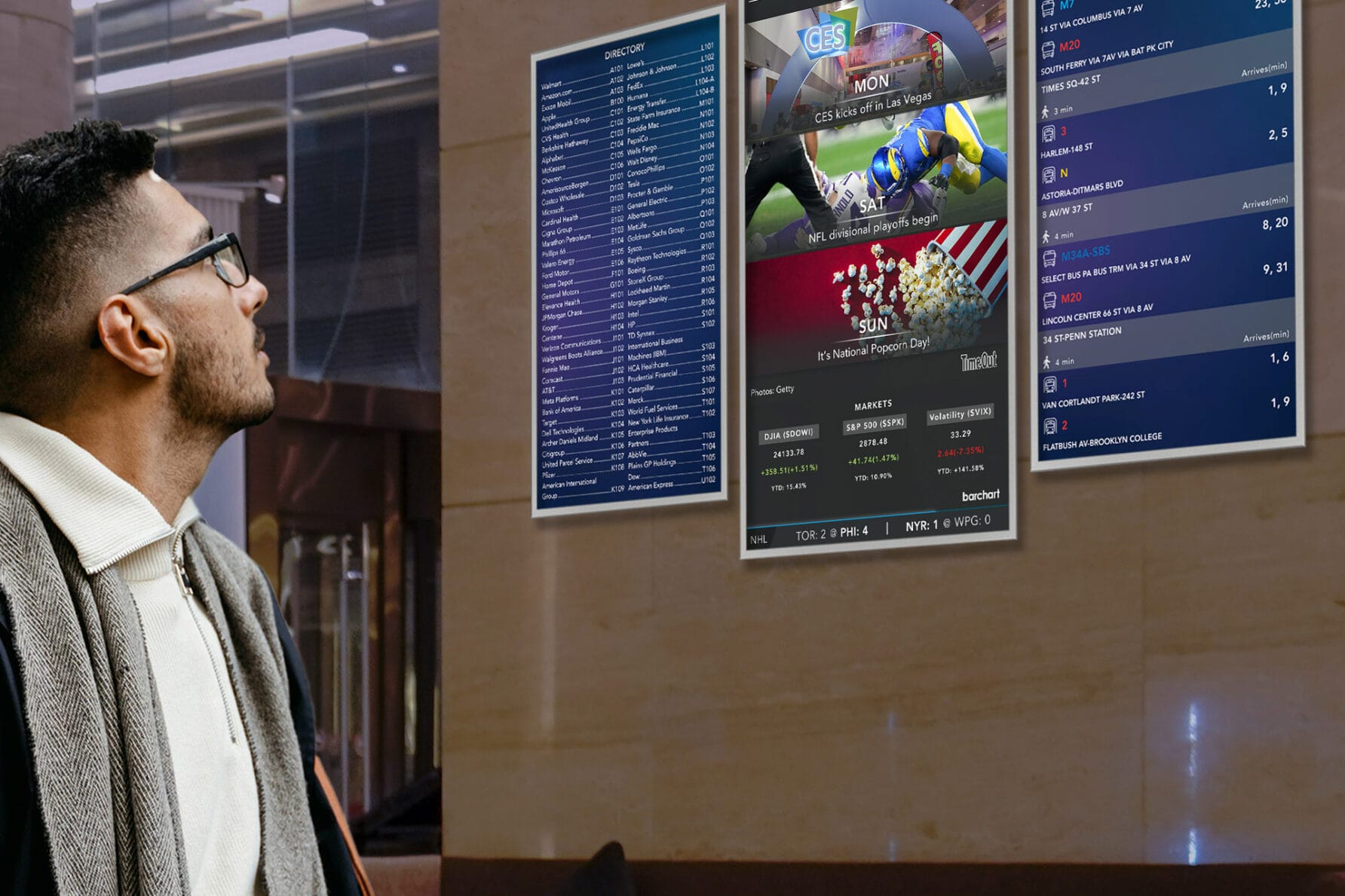 Man in a coat looking at digital screens displaying weekend sports preview in a modern indoor setting.