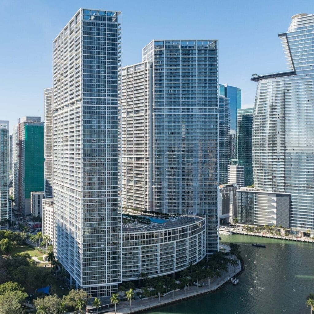 skyscrapers with modern architecture next to a waterway in a bustling city skyline