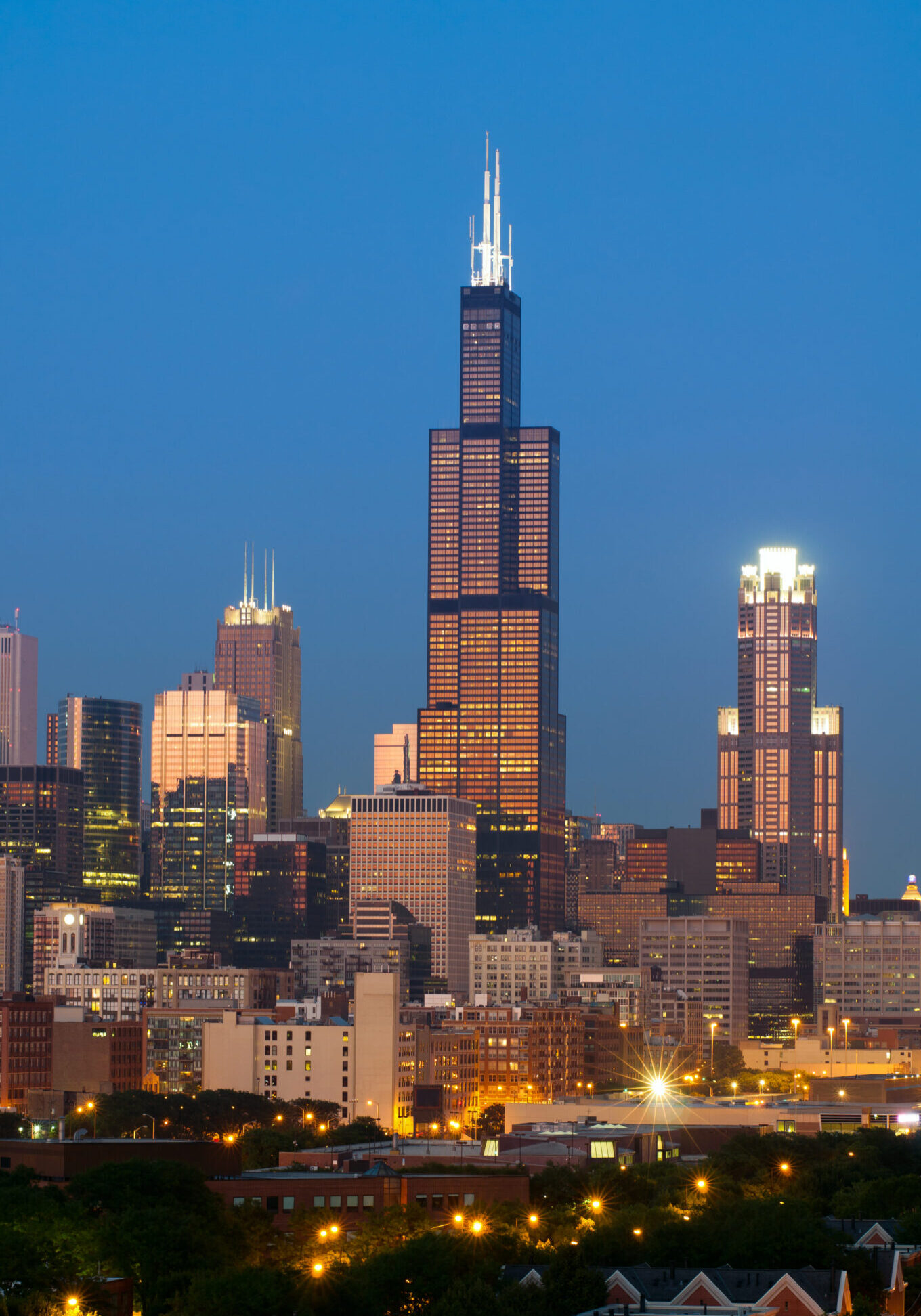 Image of Willis Tower and skyline of Chicago at sunset.
